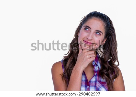 Happy pretty woman with finger on chin on white background