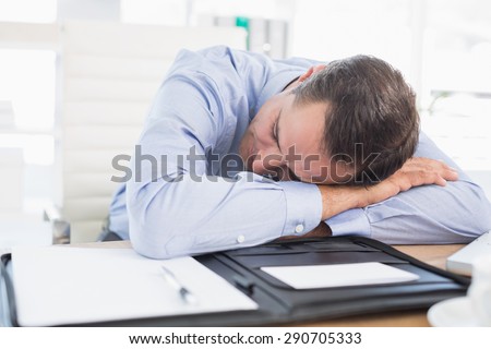 Sleeping businessman in his office