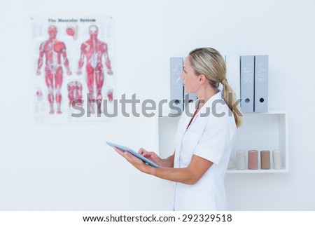 Doctor using tablet pc in medical office
