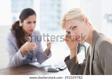 Businesswoman giving orders at her coworker in an office
