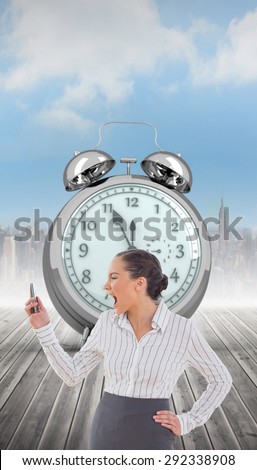 Angry businesswoman screaming at her phone against cityscape on the horizon