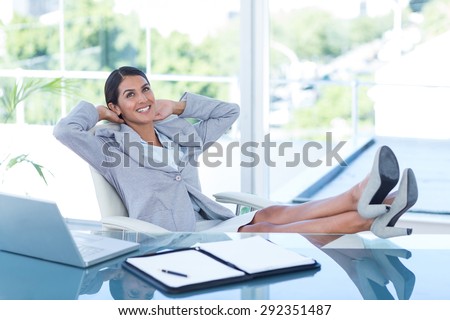 Businesswoman relaxing in a swivel chair in her office