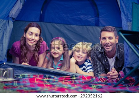 Happy family camping in the park on a sunny day