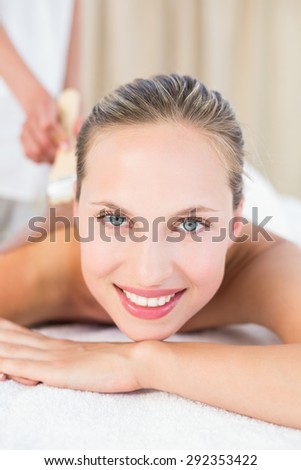 Beautiful blonde enjoying a chocolate beauty treatment at the health spa