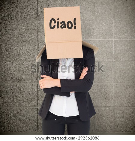 Businesswoman lifting box off head against grey room