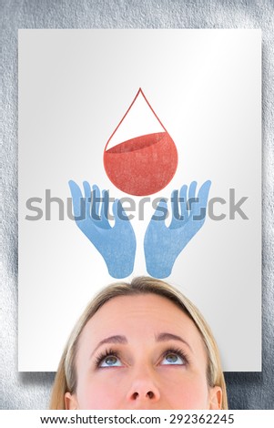 Close up of blonde woman looking up against white card