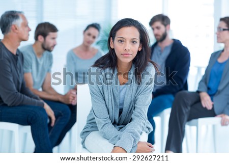 Woman comforting another in rehab group at a therapy session