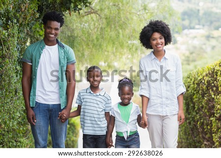 Happy family walking together in the garden at home