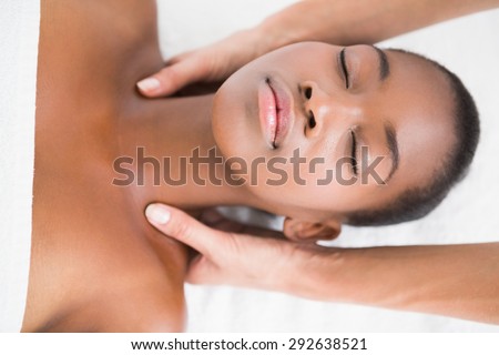 Pretty woman enjoying a shoulder massage at the health spa