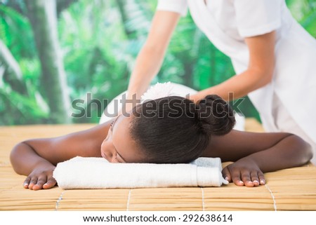 Pretty woman enjoying a back massage at the health spa