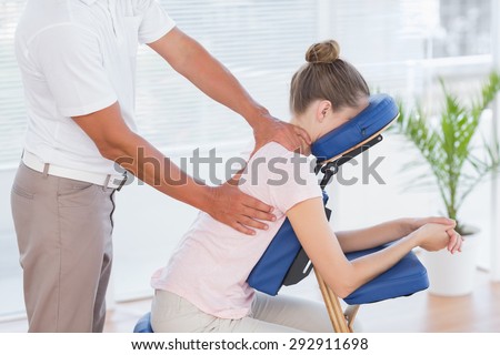 Woman having back massage in medical office