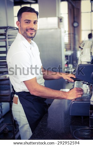 happy worker making coffee in the bakery