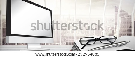 Computer screen against window overlooking city