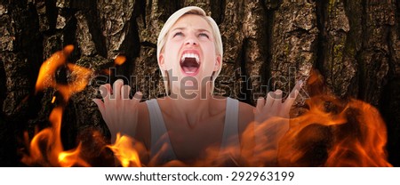 Upset woman screaming with hands up against brown rough bark
