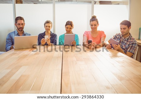 Young creative business people with laptop and digital tablet in the office