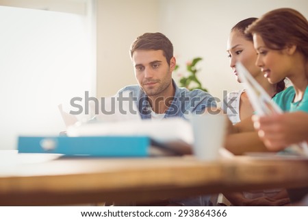 Thoughtful businessman working with his team in the office