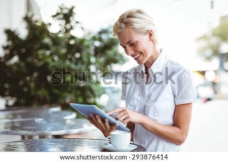 Happy pretty blonde using tablet computer