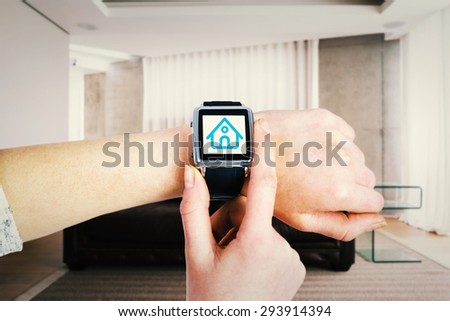 Woman using smartwatch against brown leather couch in a modern living room
