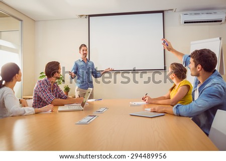 Attentive businessman asking a question in a meeting at office