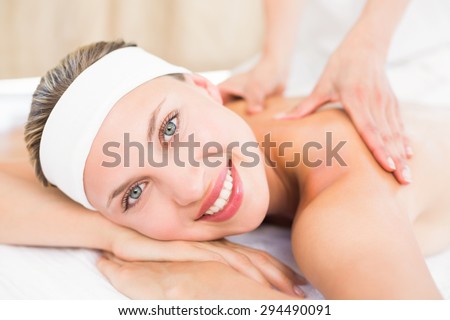 Beautiful blonde enjoying a massage at the health spa