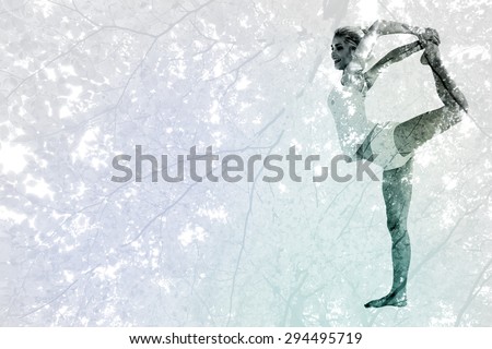 Sporty woman stretching body while balancing on one leg against branches and autumnal leaves