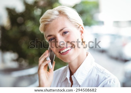 Young woman on the phone at the cafe