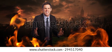 Stressed businessman gesturing against stormy sky over city
