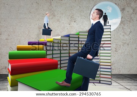 Businesswoman climbing with briefcase against steps made out of books