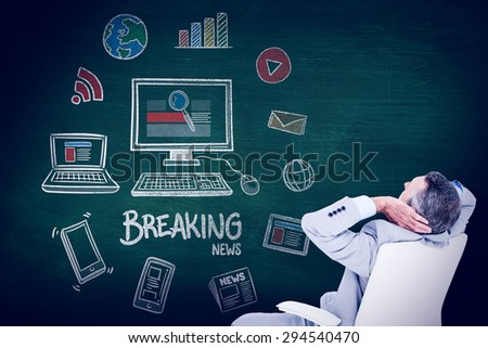 man sitting on office chair and relaxing against green chalkboard