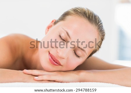 Side view of a beautiful young woman on massage table at health farm