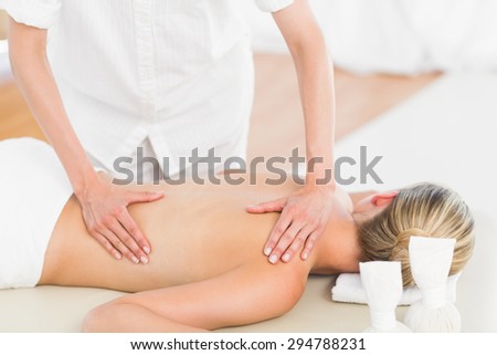 Pretty blonde enjoying a massage at the health spa