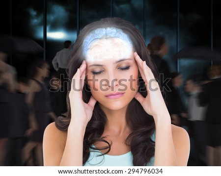 Pretty brunette with a headache against room with large window looking on city