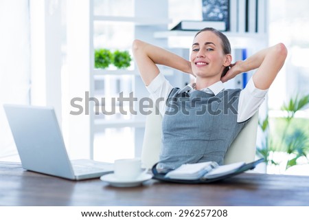 Businesswoman relaxing in a swivel chair in her office