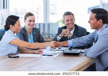 Business people shaking hands during meeting in office