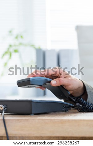 Businessman answer the phone at the office