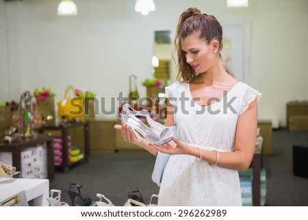 Woman looking at high-heeled sandals at a shoe shop