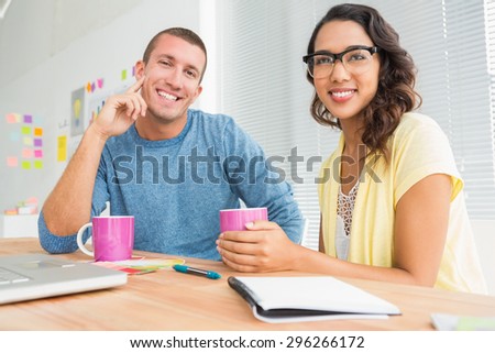 Portrait of smiling colleagues looking at camera in the office
