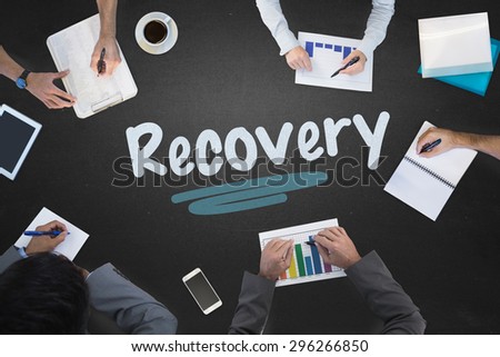 The word recovery and business meeting against blackboard