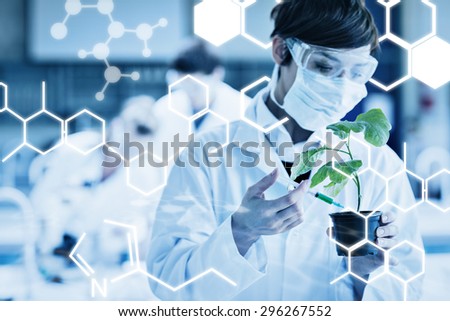 Science graphic against woman standing at the laboratory holding a plant adding chemical to soil