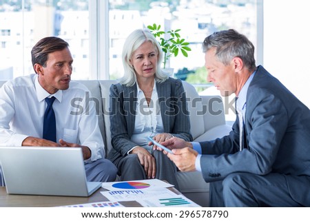 Business people speaking together on couch in office
