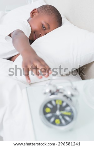 Pretty little boy wake up at morning in bed at home in bedroom
