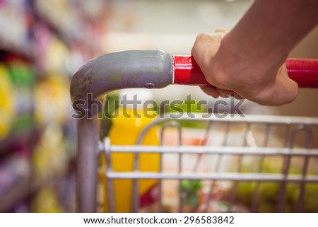 woman buy products with her trolley at supermarket