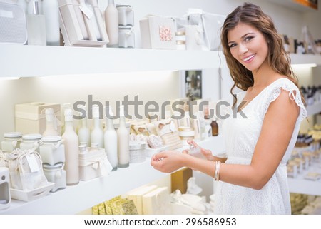 Portrait of smiling woman testing perfume at a beauty salon