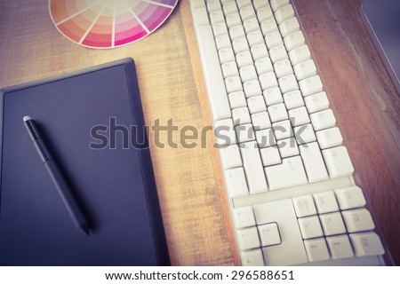 Upward view of table wood with graphic tablet and computer