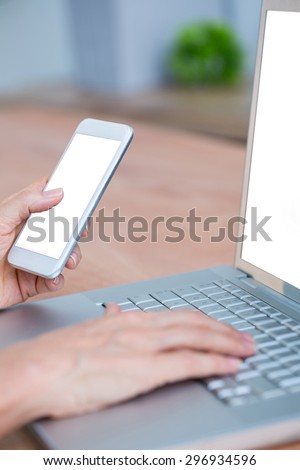 Close up view of hands typing on laptop and texting