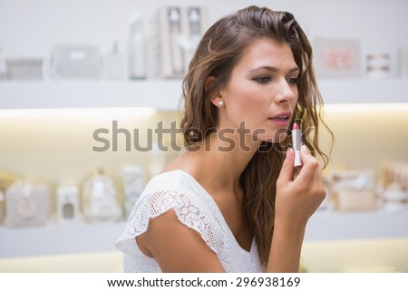 Woman testing lipstick at a beauty salon