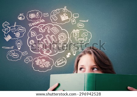 Student holding book against blue background