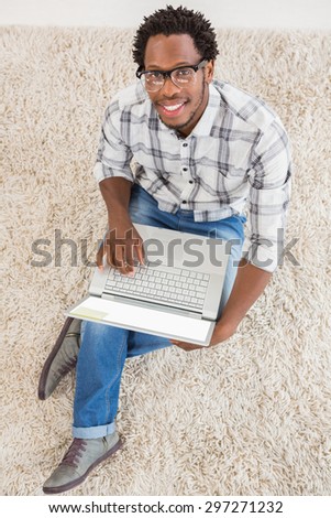 Young businessman types on the laptop in the office