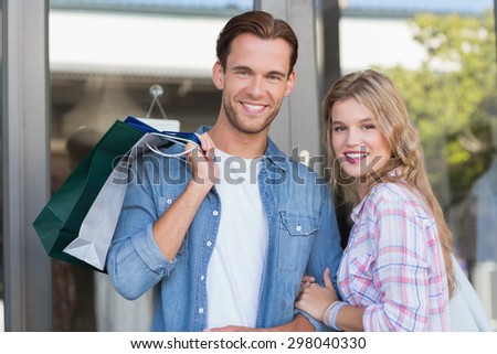Portrait of a happy couple with shopping bags at the mall