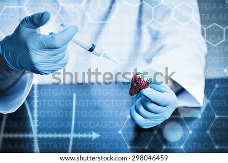 Science graphic against food scientist injecting a strawberry